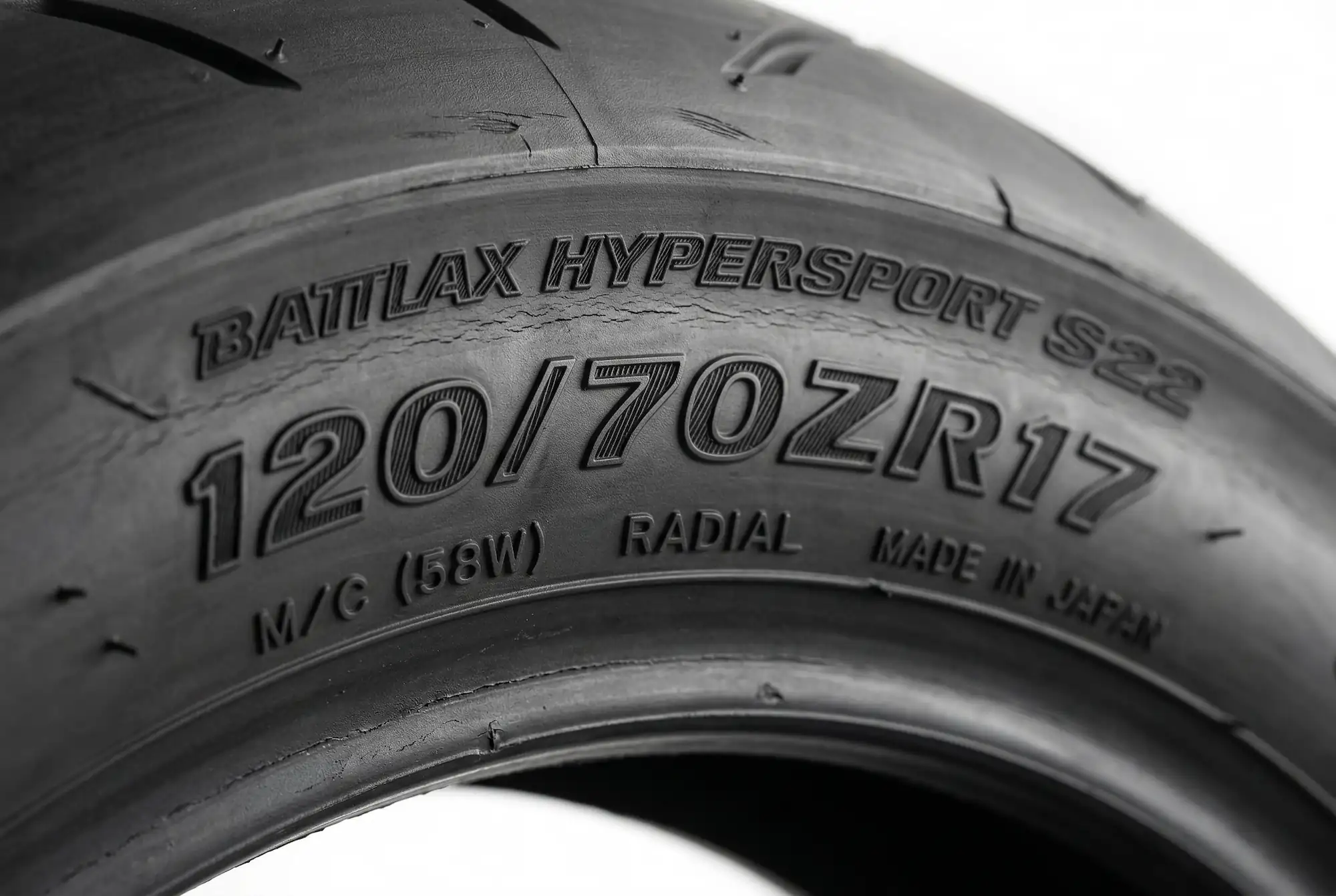 Close-up of motorcycle tire sidewall showing size markings 120/70ZR17 clearly in focus