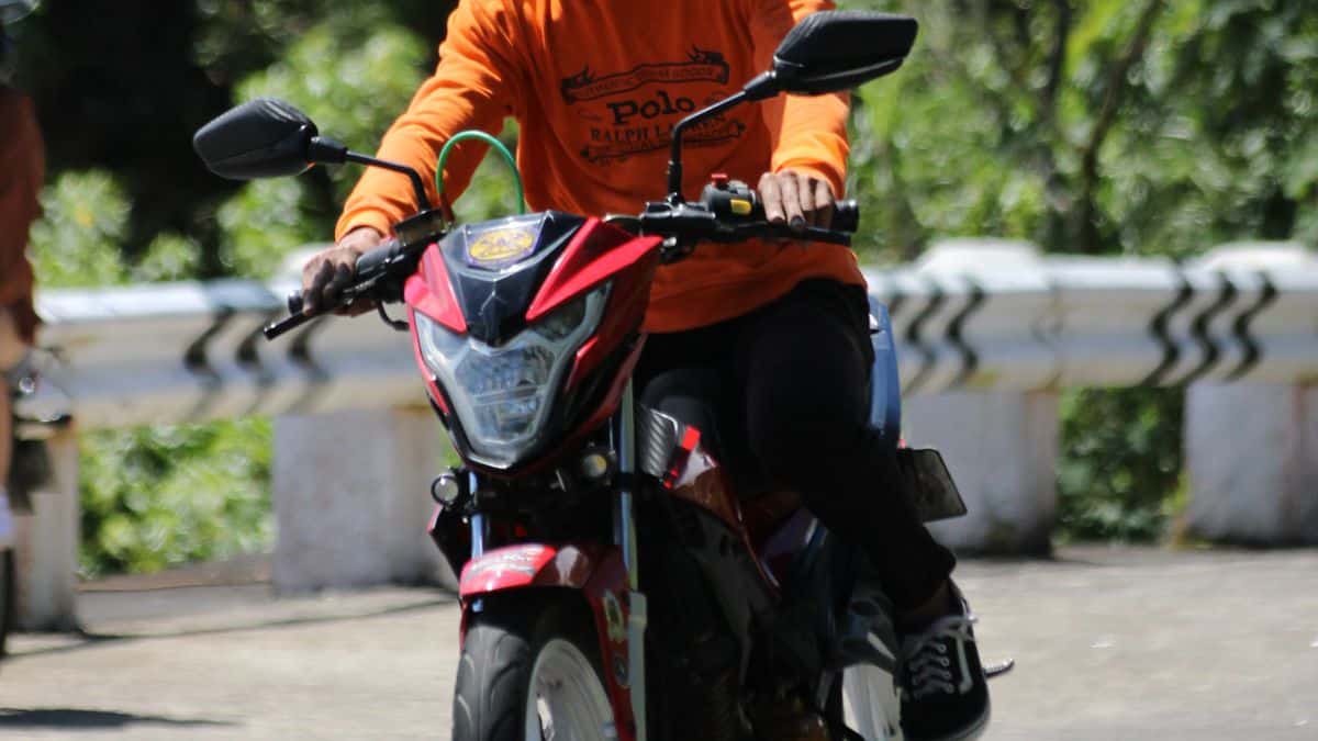 Motorcyclist riding on a sunny day, illustrating Texas helmet law requirements
