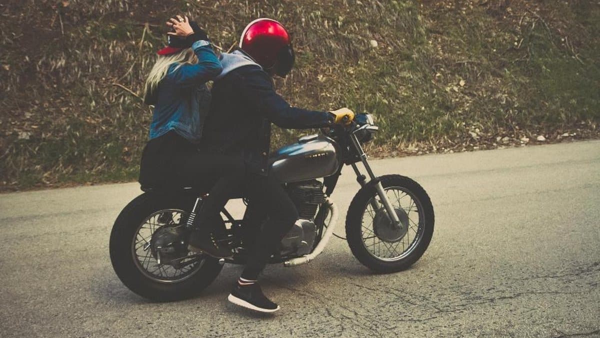 Rider and pillion passenger setting off on a motorcycle