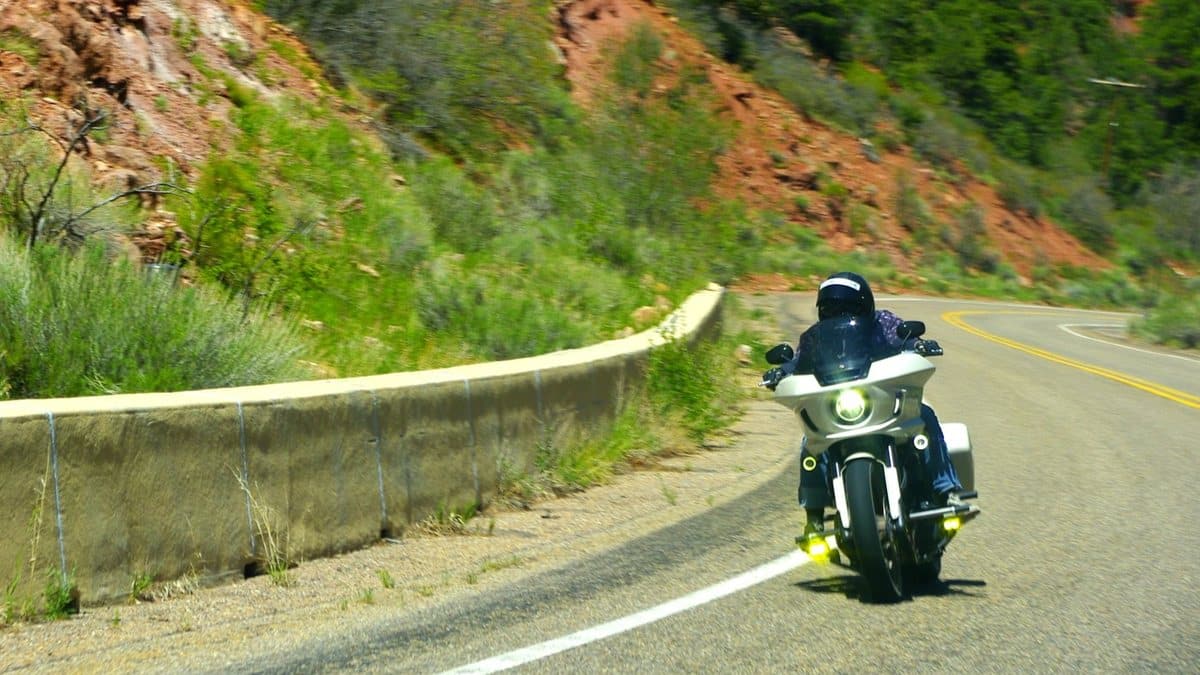 Motorcyclist riding a touring motorcycle on an open road