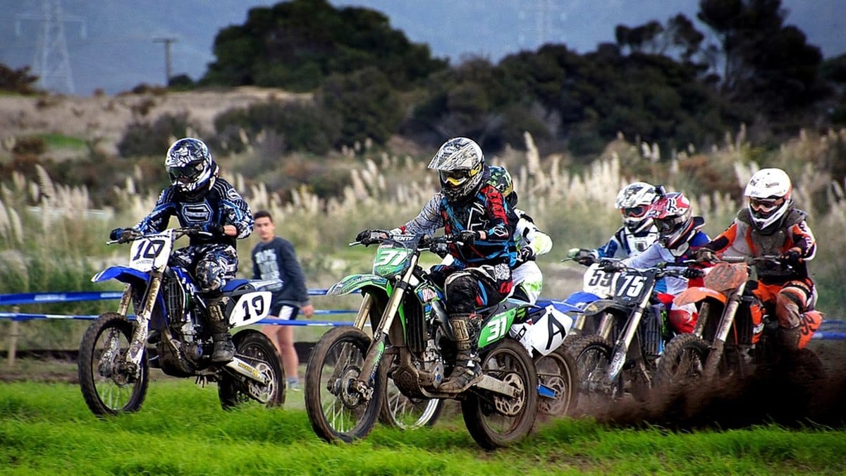 Motocross rider in full riding gear including gloves