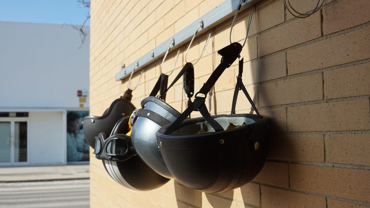 Several motorcycle helmets side by side, showing different shell shapes