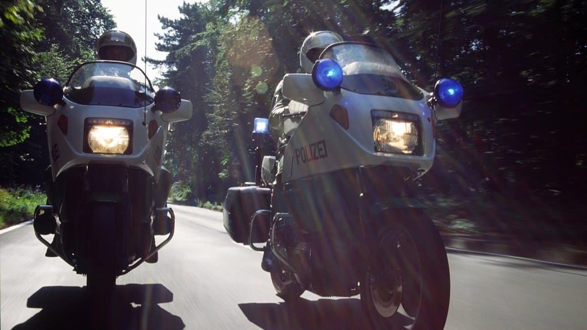 Two riders on motorcycles travelling together on a road